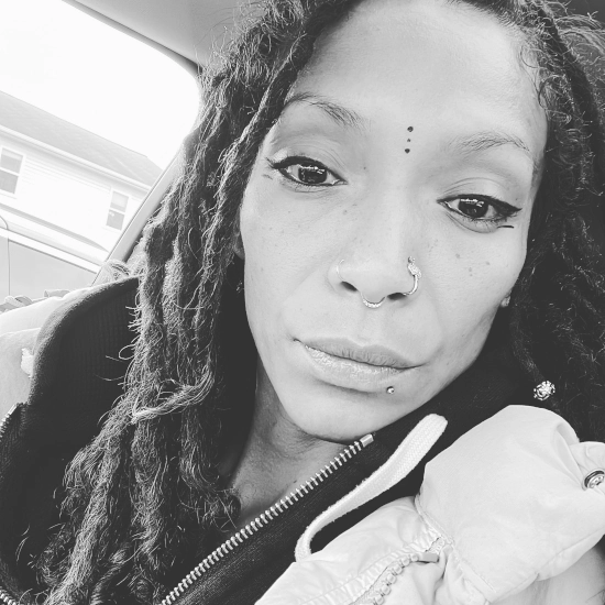 Portrait of Feather Marie, founder and wellness coach at Indigo Feathers